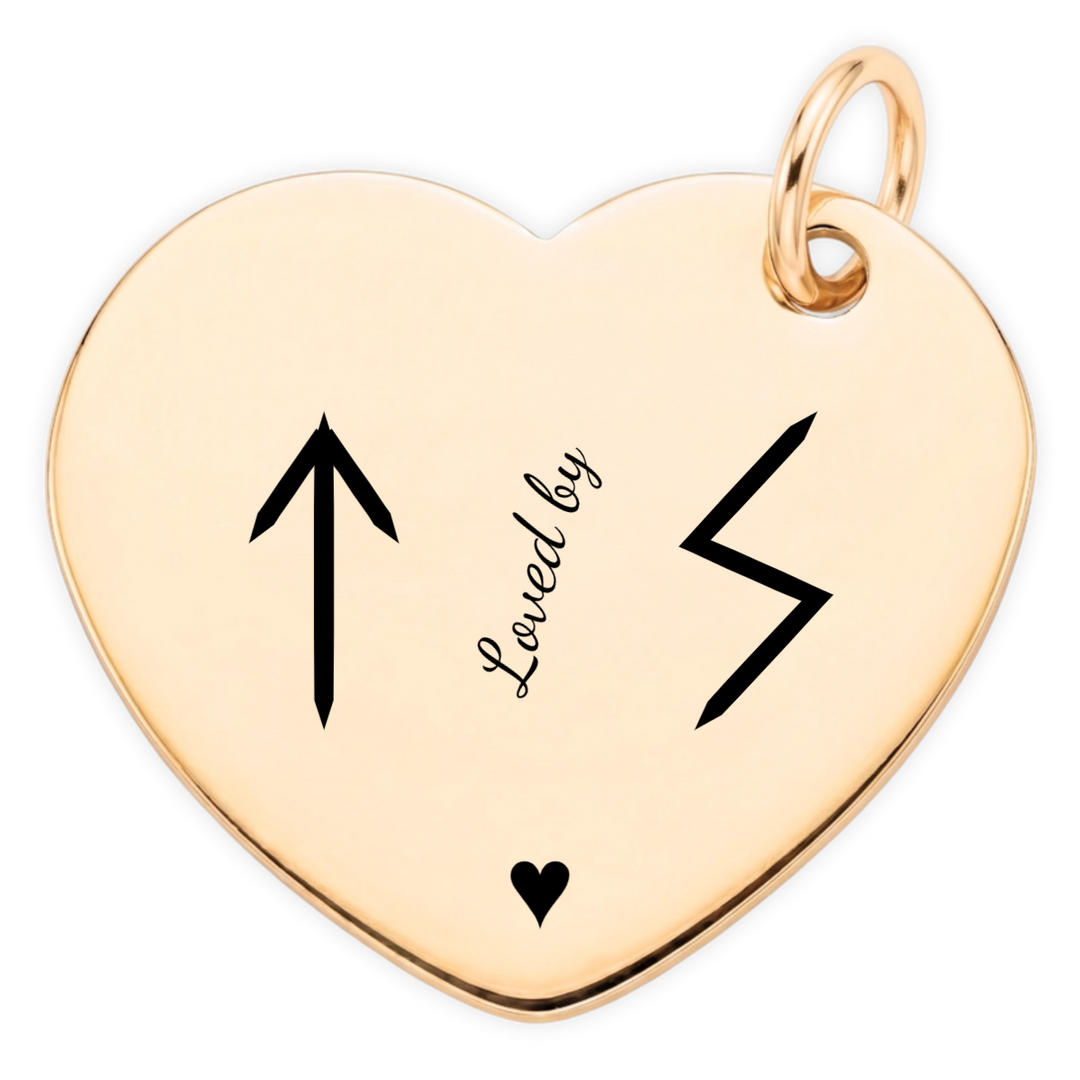Loved By gold heart pendant engraving close-up: Teiwaz and Sowilo runes, angled Loved by lettering and heart